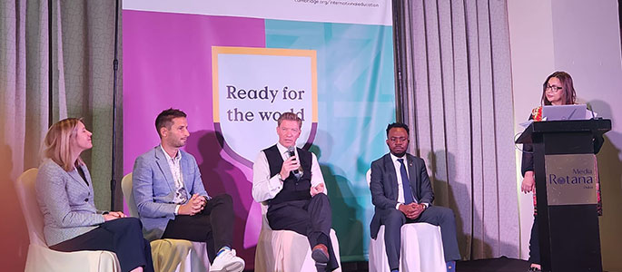 Speakers on a stage at an event