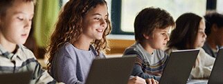 Group of young people working at laptops