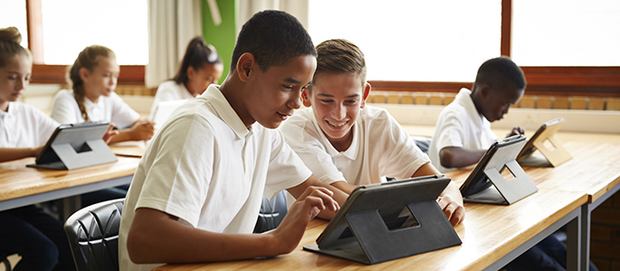 School students in class working with tablets