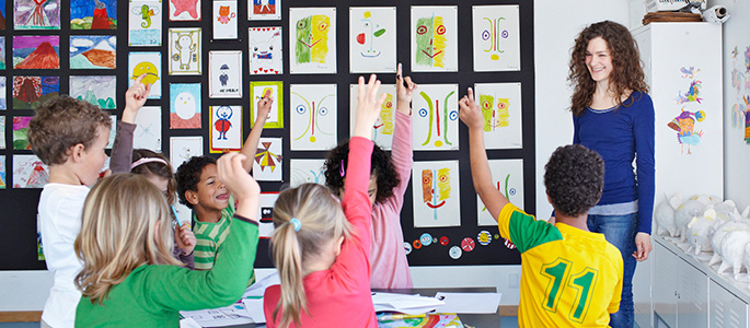 Students in class raising their hands