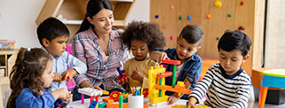 Supervisor with children playing with abacus toys